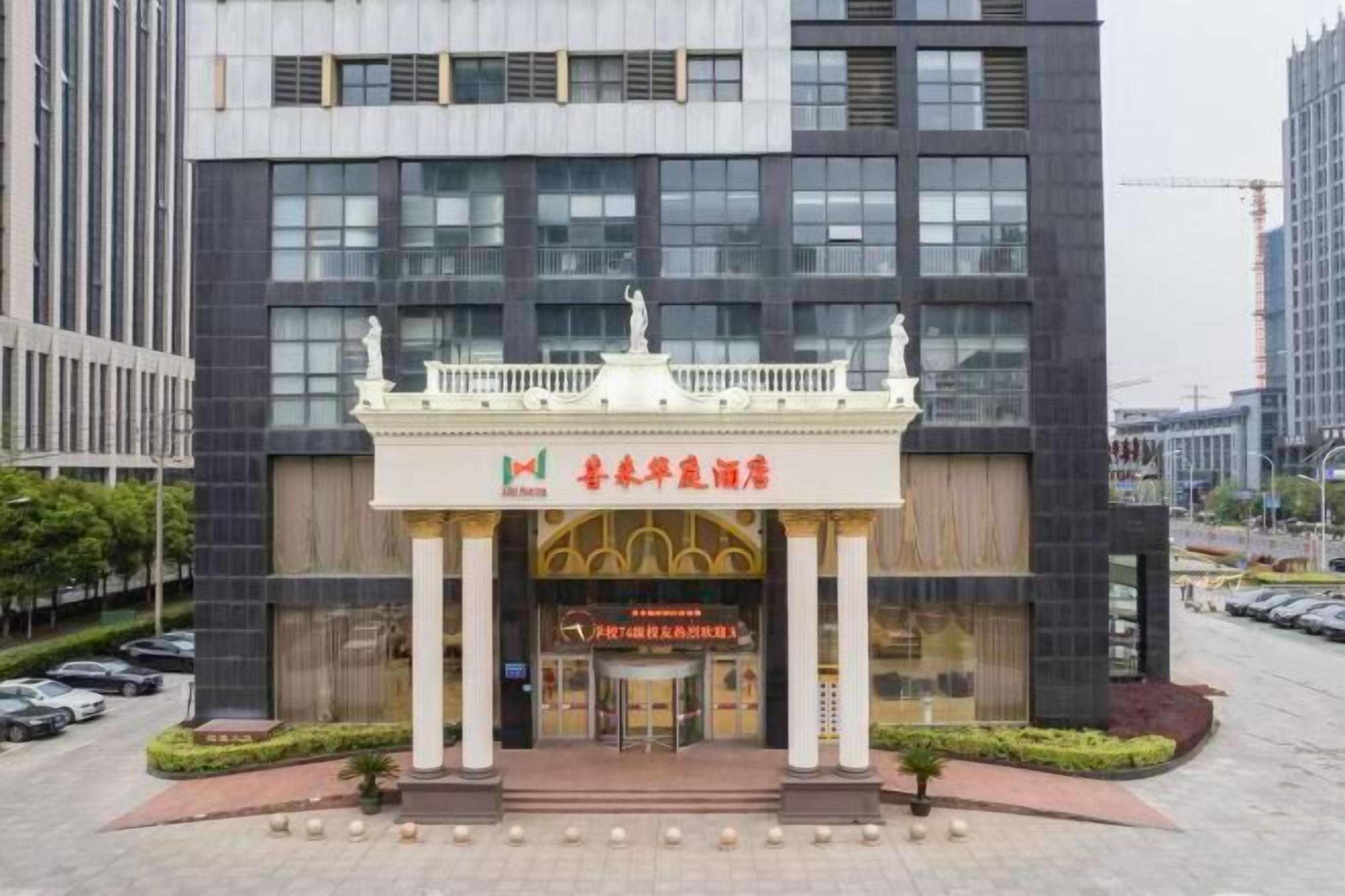 A hotel entrance with a modern facade, a central entrance, and a decorative canopy.
