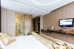 A hotel room with a bed, a television, a bathroom, and a wooden wall. - Boxiyueli Hotel (Wuxi Yuantouzhu Scenic Area) (Wuxi)