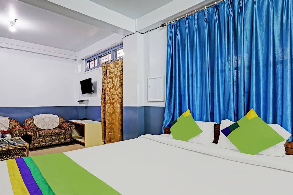 Desk, iron/ironing board, bed sheets