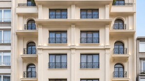 A multi-story hotel with a classic architectural style, featuring balconies with wrought iron railings and a ground-level entrance with a sign reading 'PRINCELY SUITES.' - Princely Suites (Istanbul)