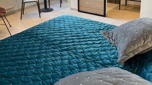 Un dormitorio con una cama grande, un escritorio y una puerta corrediza que da a un baño.