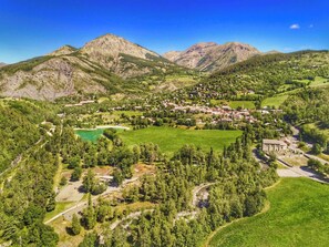 A mountainous landscape with a village nestled in a valley.