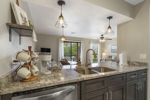 Enjoy cooking in this well-equipped kitchen with a coffee station, wine cooler, and dishwasher.
