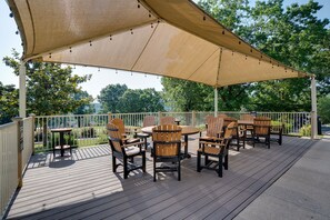 Relax under the shade of a spacious canopy, surrounded by lush gardens and comfortable seating.