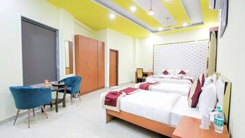 A hotel room with two beds, a desk, a chair, and a wardrobe.