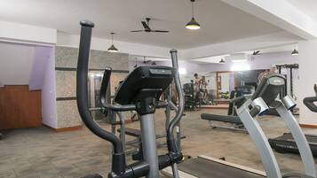 A gym with treadmills, elliptical machines, and weight equipment.