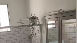 A bathroom with a shower, a sink with a mirror, and a patterned floor. - Unique: Villa with pool in the heart of Nice (Nice)