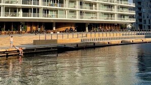 A modern multi-story hotel with a flat facade, large windows, and a waterfront location. - STAY Nordhavn (Copenhagen)