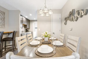 Enjoy meals together at this inviting dining area, featuring a beautifully set table for four.