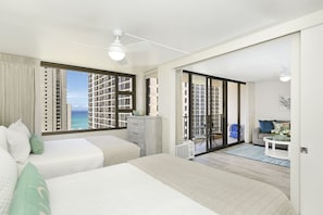 Relax in a spacious room with a large bed, sofa, and balcony offering ocean views.