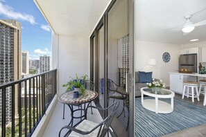 Relax on the balcony with a city view, or unwind in the living area with a sofa and coffee table.