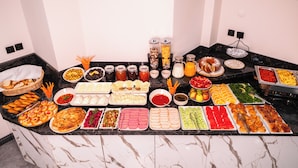 A buffet with various food items and condiments. - Polek Hotel (Çanakkale)