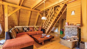 A cozy wooden interior with a sofa, coffee table, and a fireplace. - Beautiful 3-bed House in Crni Lug (Delnice)
