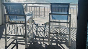 A balcony with two chairs facing a beach view. - LIVE ON THE BEACH. Gulf Beach Front - Spectacular views. (Indian Shores)