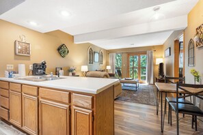 Kitchen area with sink, ample storage, and dining space.