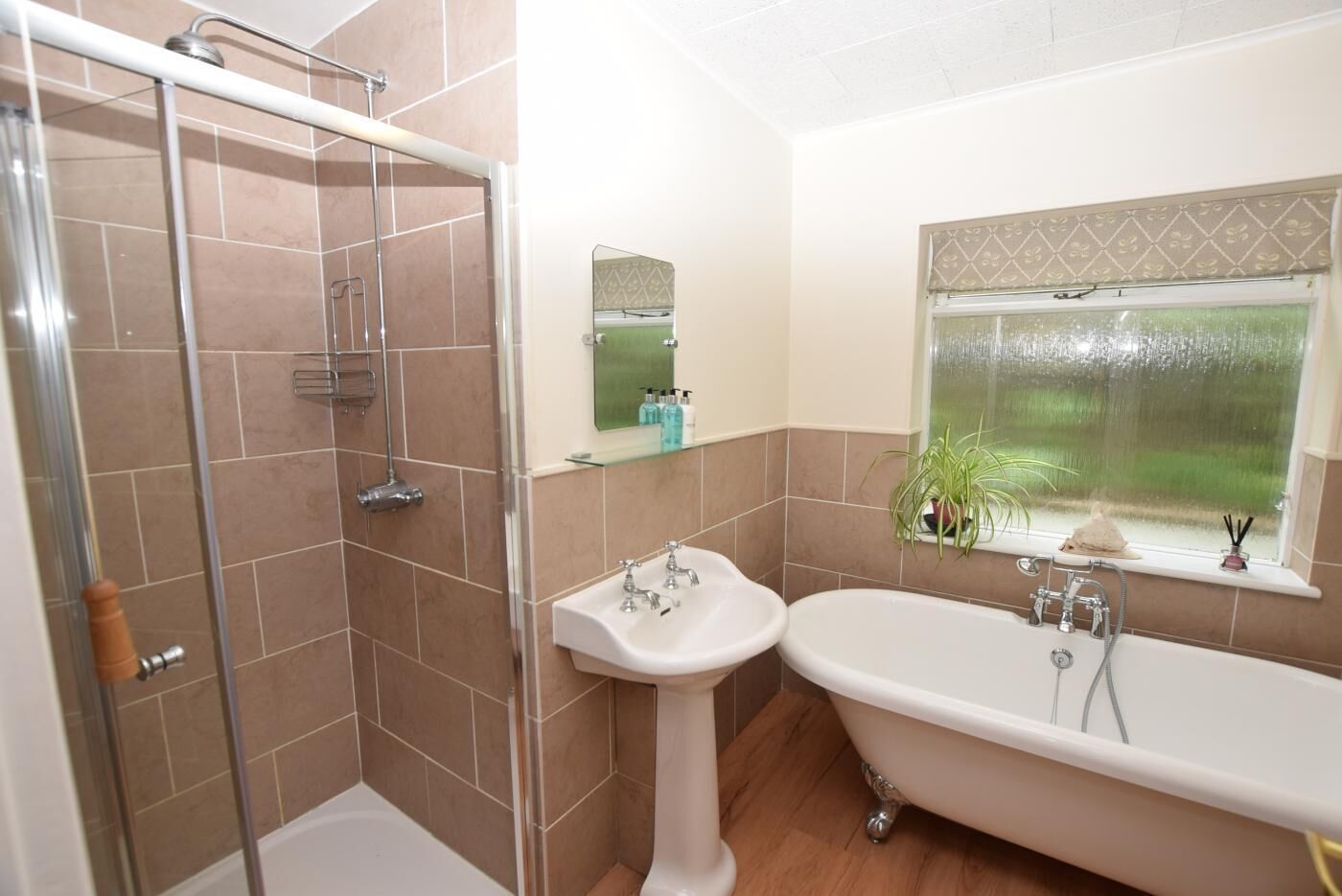 A bathroom with a shower, sink, and bathtub.