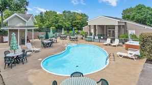 A pool area with lounge chairs, tables, and umbrellas. - Boatin & Floatin on Table Rock Lake in the Ozarks! (Kimberling City)
