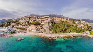 A coastal town with a historic castle, clear turquoise waters, and a mountainous backdrop. - Pool Villa Luxoria Trebesin (Herceg Novi)
