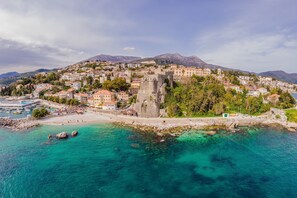 A coastal town with a historic castle, clear turquoise waters, and a mountainous backdrop. - Pool Villa Luxoria Trebesin (Herceg Novi)