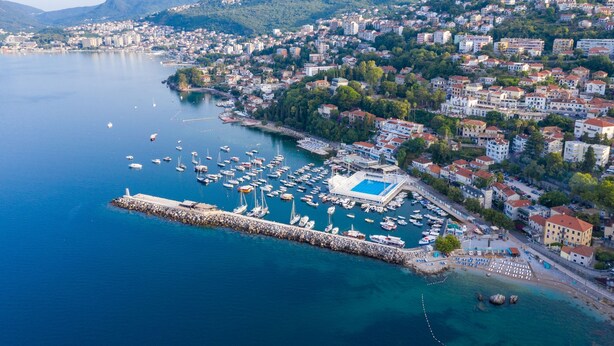 An aerial view of a coastal town with a marina, buildings, and mountains in the background. - Pool Villa Luxoria Trebesin (Herceg Novi)