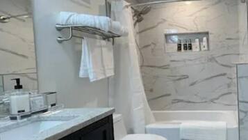Combined shower/tub, hair dryer, towels, soap