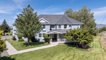 A two-story house with a front porch and a well-maintained lawn.