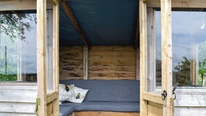 A wooden cabin with a built-in bed, a dark ceiling, and a window on the left. - Bogrie Country Cottage (Annan, Dumfries)