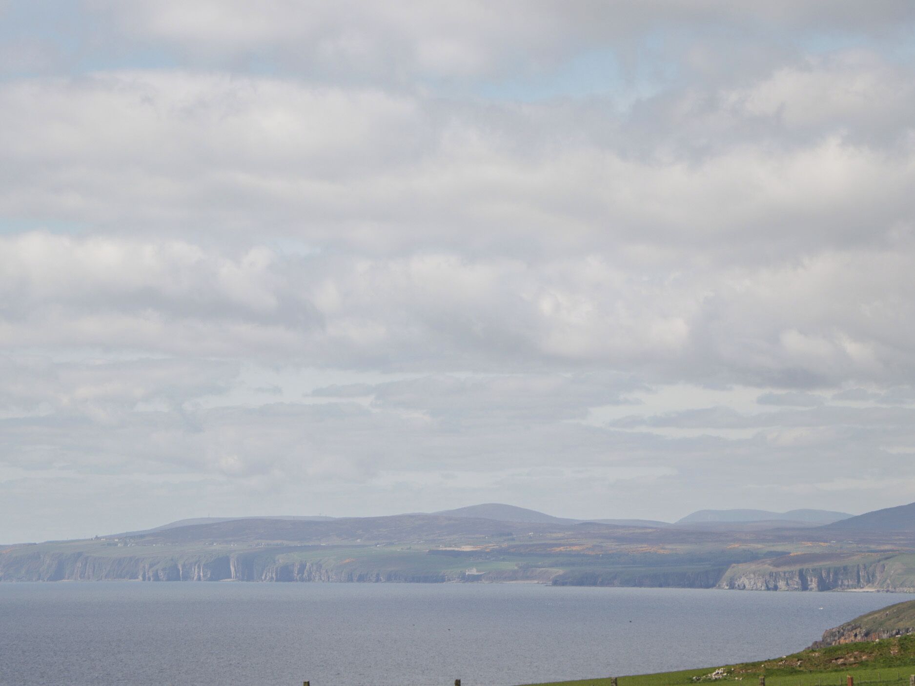 A coastal landscape with cliffs and a body of water.