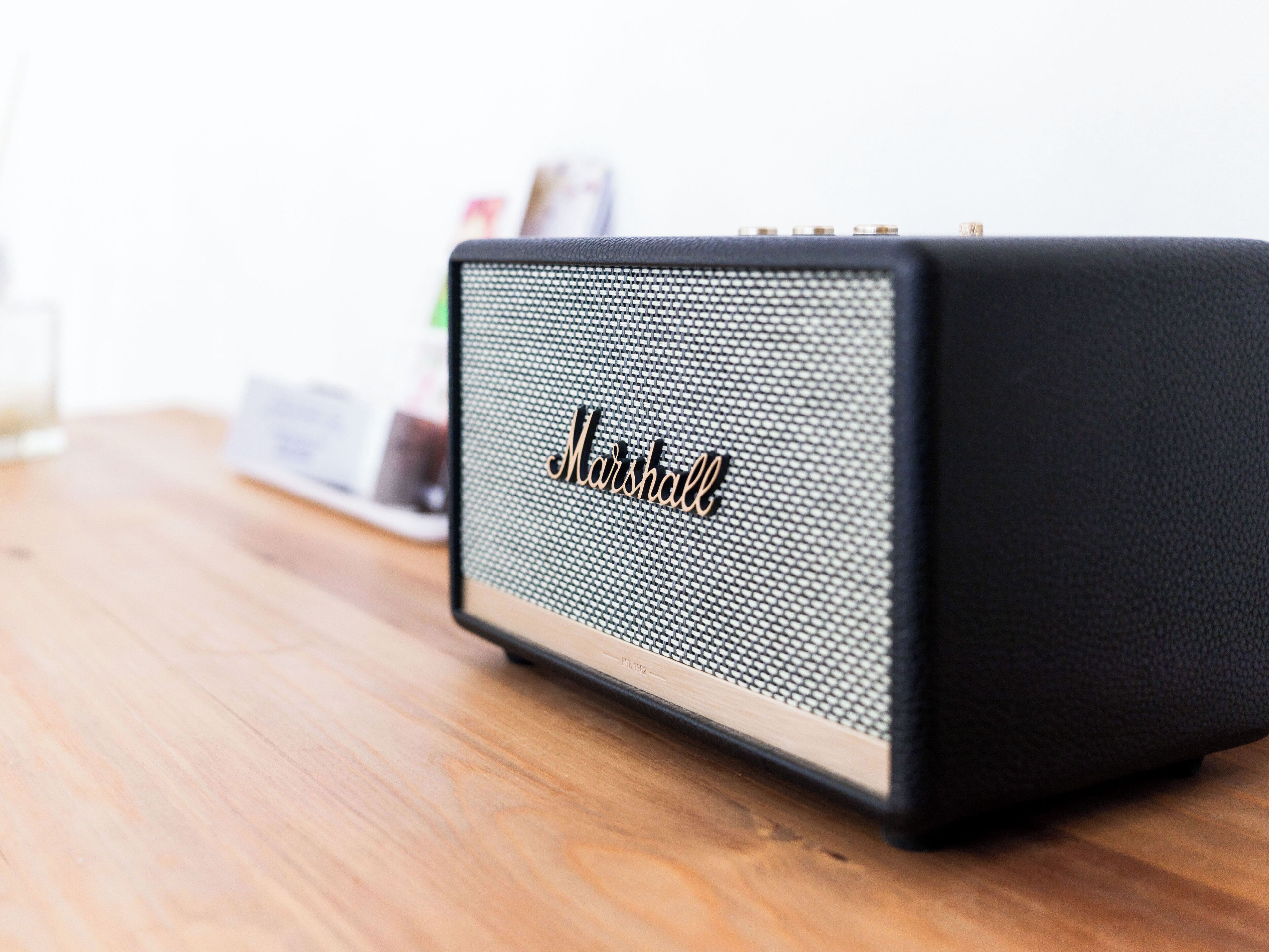 A Marshall speaker on a wooden table.