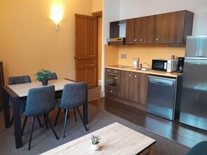 A modern kitchen with wooden cabinets, a built-in oven, a dishwasher, and a microwave. - 2nd floor, swimming pool, hammam, parking, tv, 35m², Pra Loup (Jausiers)