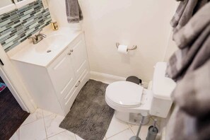 Bathtub, hair dryer, towels, shampoo