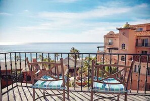 Enjoy the serene sea views from this balcony with comfortable seating for two.