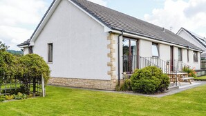 A modern two-story house with a sloped roof, stone foundation, and a small porch with a railing. - 4 bedroom accommodation in Spittalfield, nr Dunkeld (Spittalfield, nr Dunkeld)
