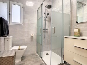 Een douche, een haardroger, handdoeken, toiletpapier