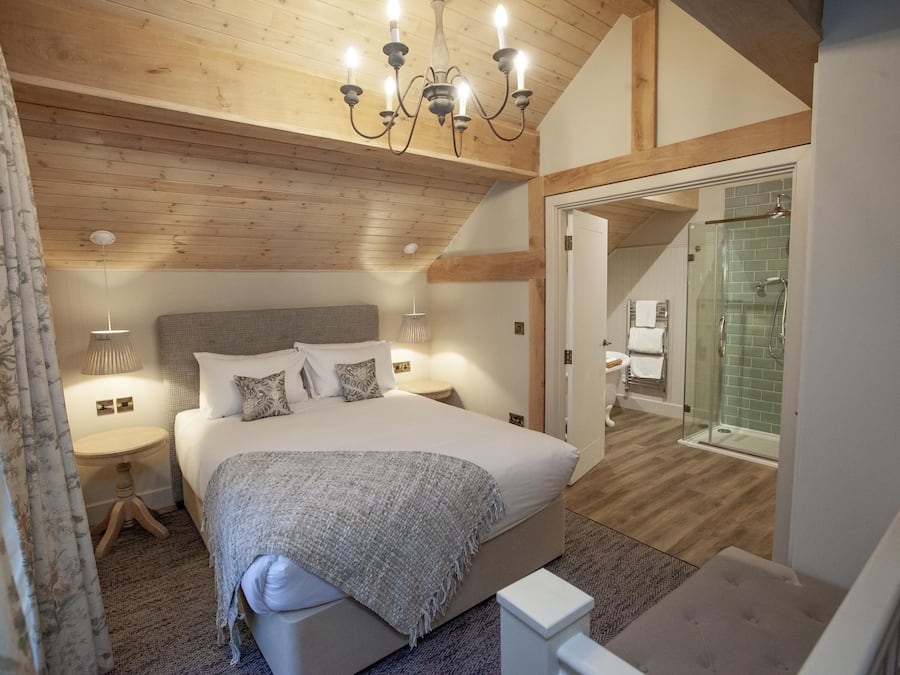 Deluxe Quadruple Room | Desk, laptop workspace, blackout drapes, iron/ironing board