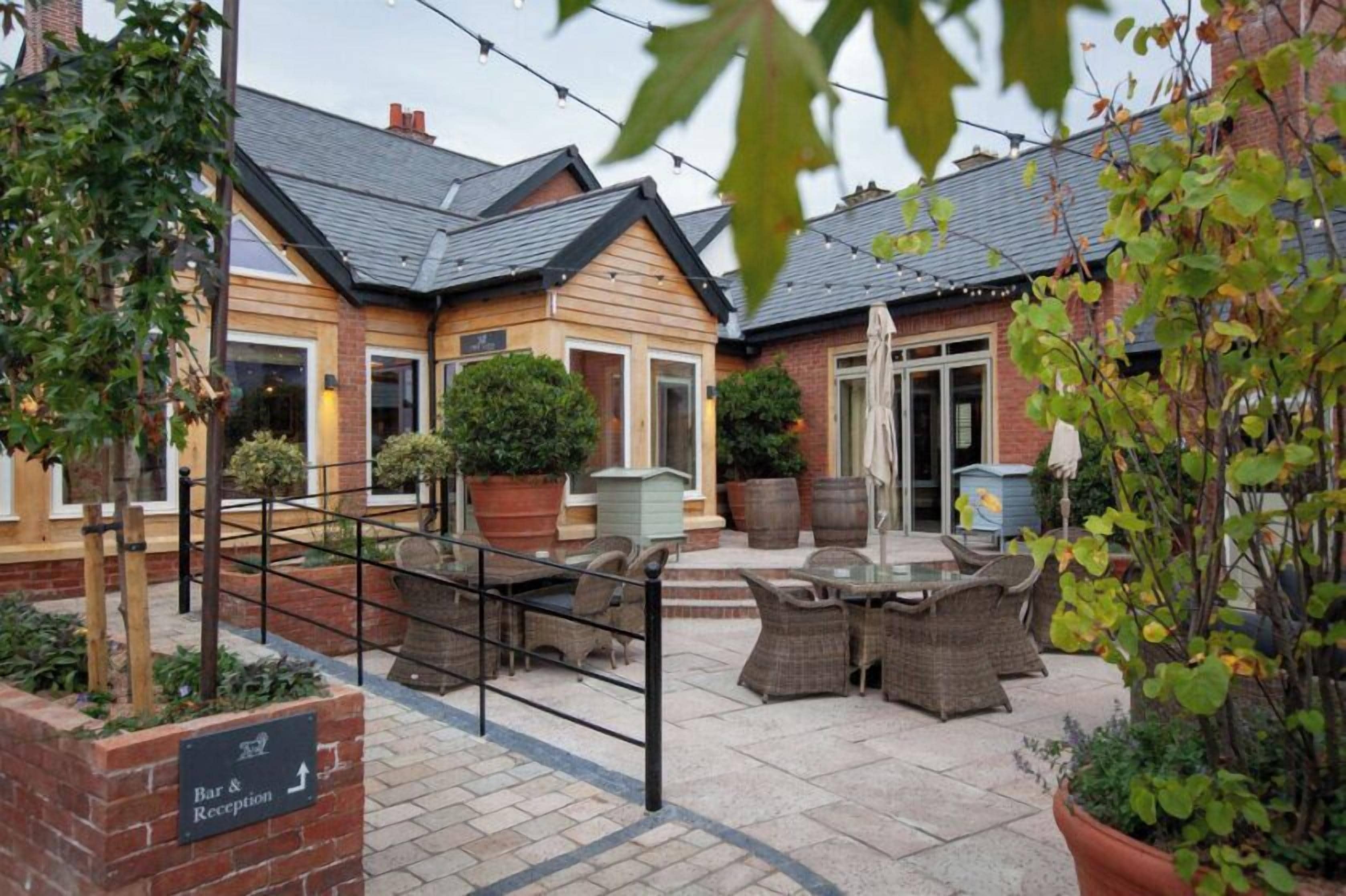 A courtyard with outdoor seating, a reception area, and a bar.