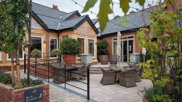 A courtyard with outdoor seating, a reception area, and a bar.