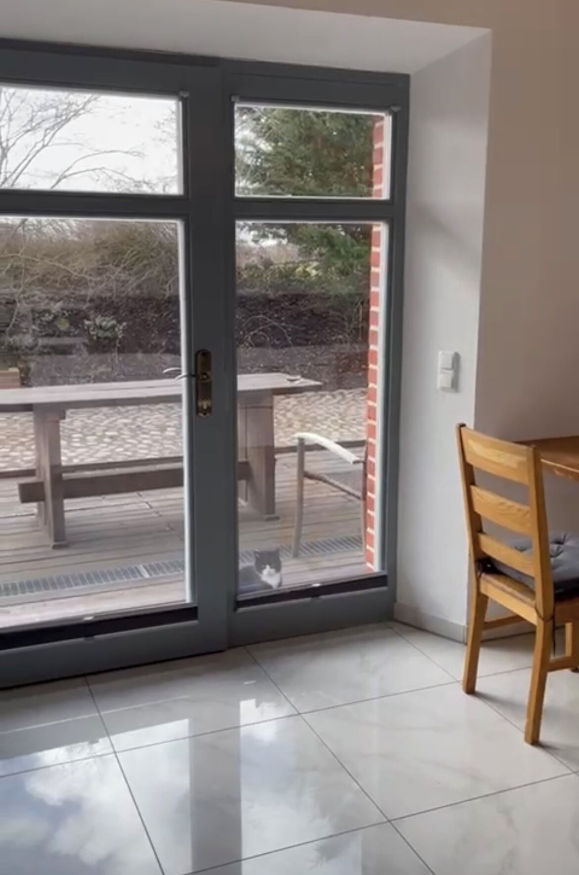 A room with a sliding glass door leading to an outdoor patio area.