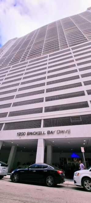 A tall building with the address "1200 Brickell Bay Drive."