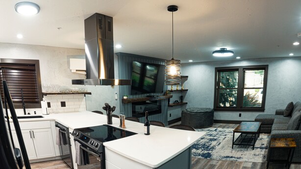 A modern kitchen with a central island, a dining area with a sofa, and a large window providing natural light. - The Reserve NEW condo, 2 blocks to Walla Walla Main Street (Walla Walla)
