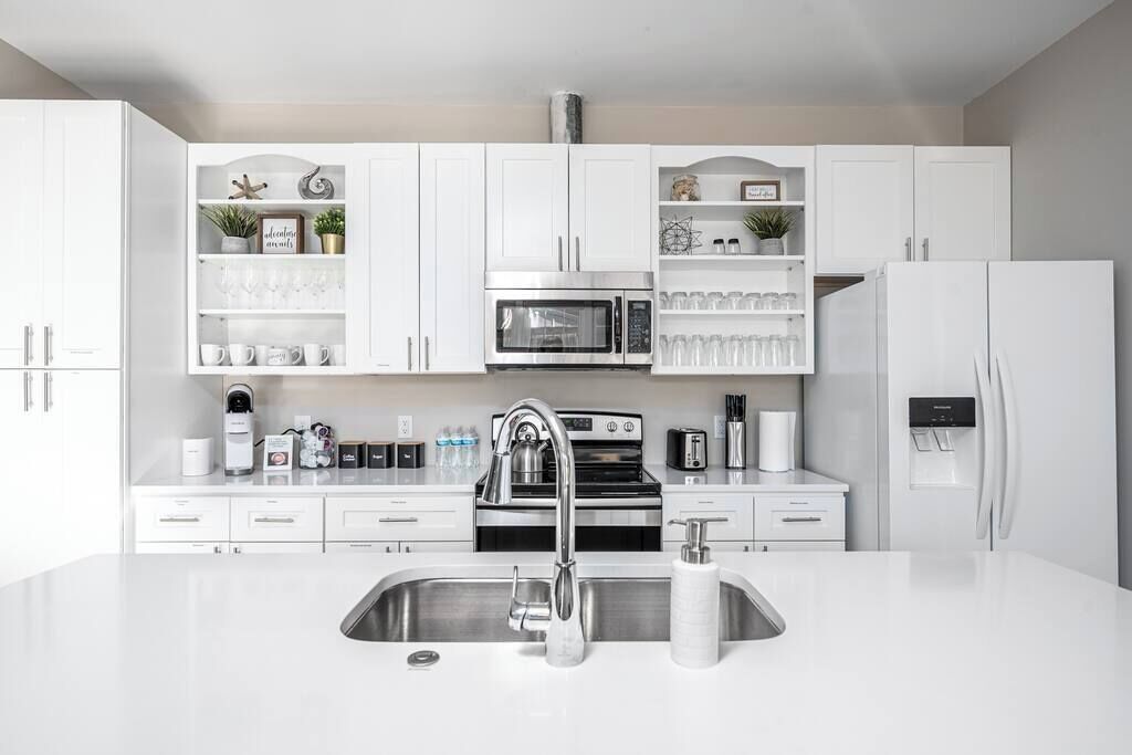 Fridge, dishwasher, coffee/tea maker, cookware/dishes/utensils