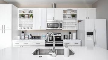 Fridge, dishwasher, coffee/tea maker, cookware/dishes/utensils