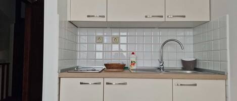 Fridge, stovetop, cookware/dishes/utensils, dining tables