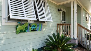 A house with a porch, a sign reading "House of Zen," and a number "253" on the wall.