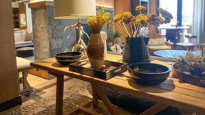 A wooden table with a vase of dried flowers, a lamp, and a bowl. - 5 Star Hotel - Exclusive Private Residence (Mountain Village)