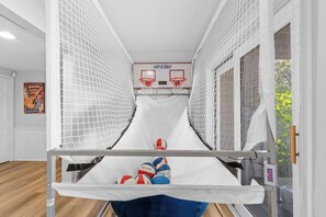 A narrow room with a basketball hoop and a poster on the wall. - Ultimate Lakeview w/ Private Outdoor Pool, Hot Tub, Yard, Karaoke, Billiards, Arcade & Free Tickets (Branson)