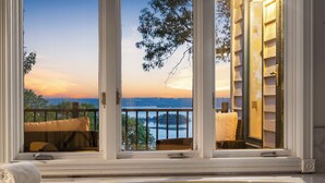 A view from a window overlooking a body of water and a sunset. - Ultimate Lakeview w/ Private Outdoor Pool, Hot Tub, Yard, Karaoke, Billiards, Arcade & Free Tickets (Branson)