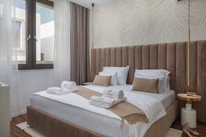 A modern hotel room with a large bed, a bedside table, and a view of the outside. - The Palms Resort - Villa Dream III (Tkon)