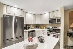 Enjoy cooking in this fully equipped kitchen with a refrigerator, microwave, stove, coffee maker, and toaster.