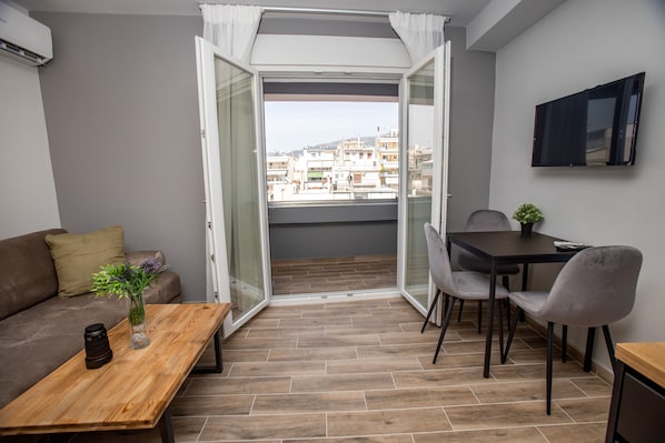 Deluxe Apartment | Living area | 32-inch Smart TV with digital channels, TV - Raise Averof Serviced Apartments (Dafni-Ymittos)